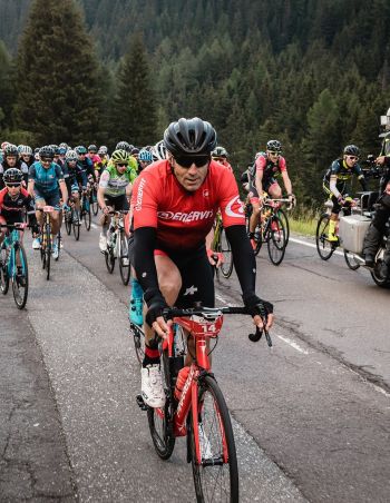 Take part in the Maratona dles Dolomites — one of the largest cycling events in the world
